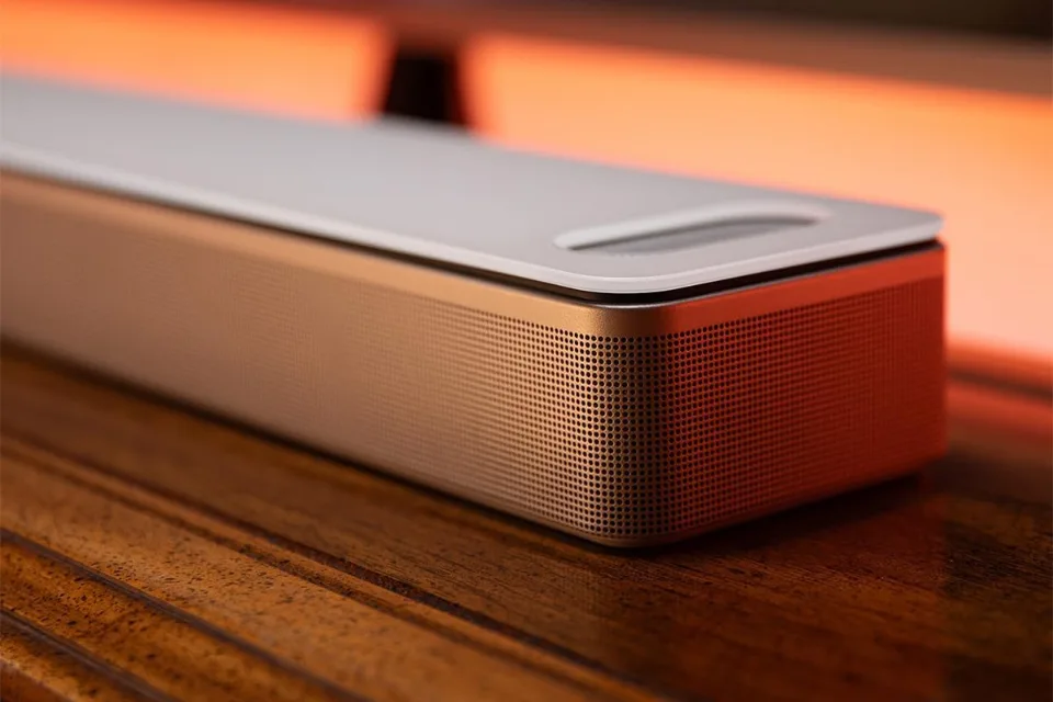 Weiße Soundbar im Detail mit Glasdeckel, Öffnung für den Höhenkanal und Metallgitter